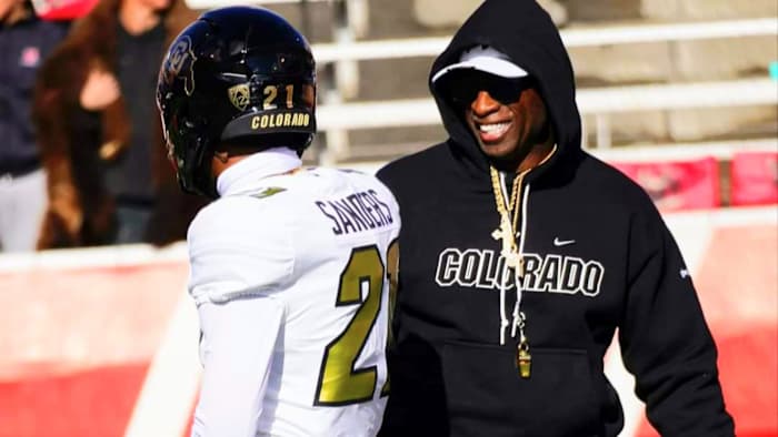 Deion Sanders on the field at Rice-Eccles Stadium in Utah